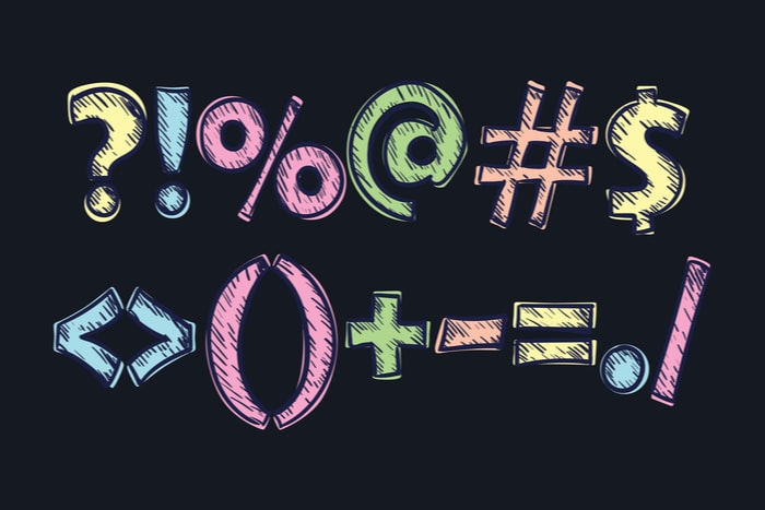 Colorful chalk-style symbols and punctuation marks on a dark background, including numbers and mathematical operators.